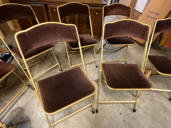 A set of eight folding chairs with
