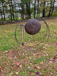 A round Iron firewood holder with a