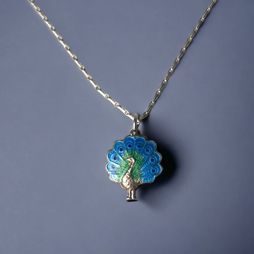 A STERLING SILVER GUILLOCHE ENAMEL PEACOCK