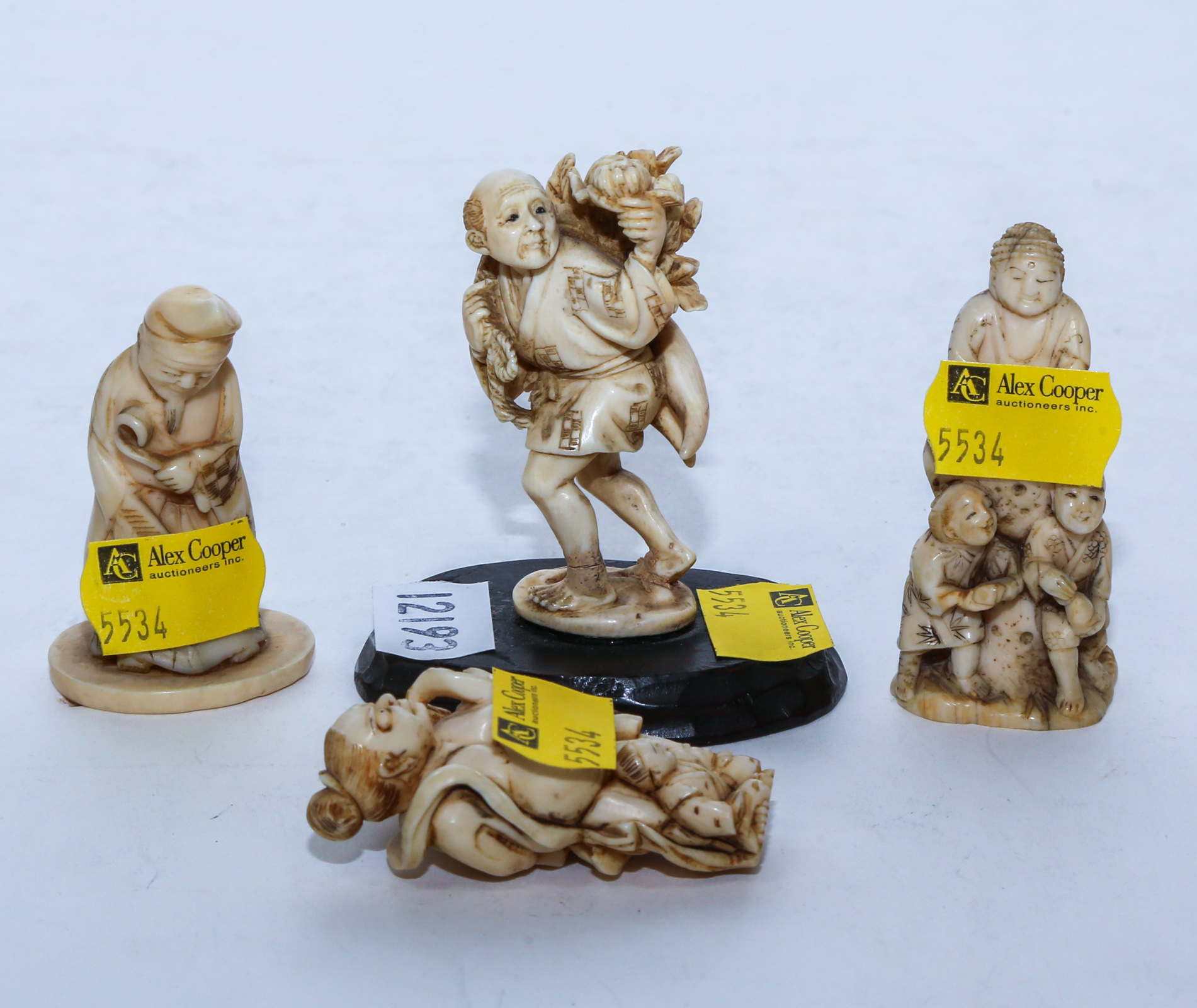 FOUR JAPANESE CARVED OKIMONO & NETSUKE