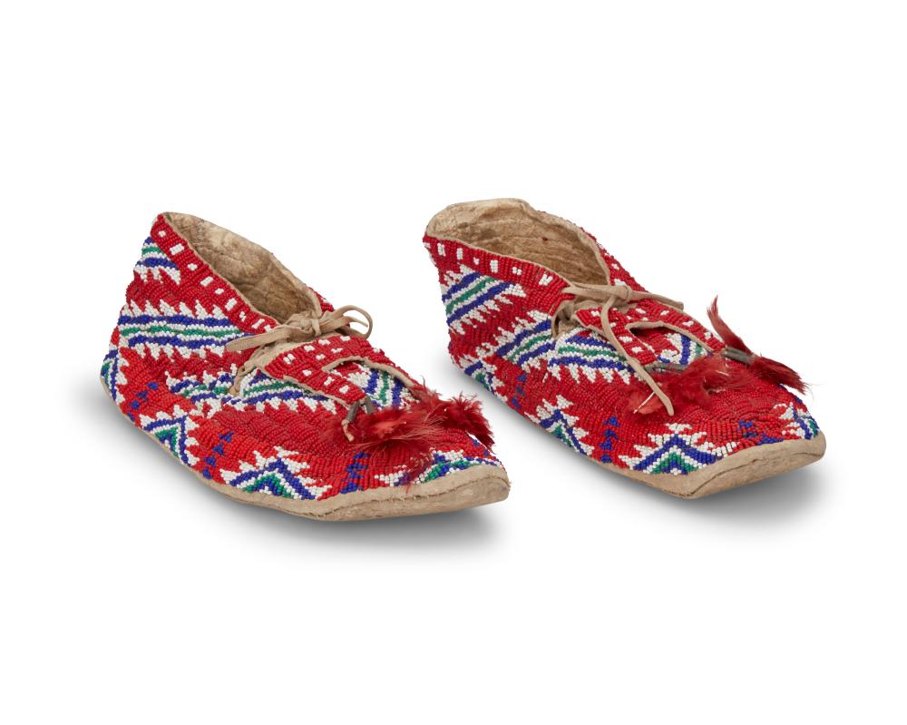 A PAIR OF SIOUX BEADED HIDE MOCCASINSA