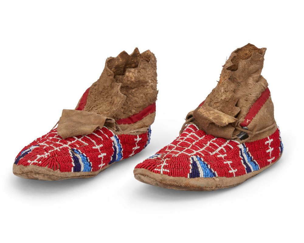 A PAIR OF SIOUX BEADED HIDE MOCCASINSA