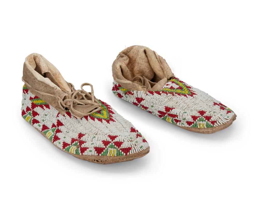 A PAIR OF SIOUX BEADED HIDE MOCCASINSA