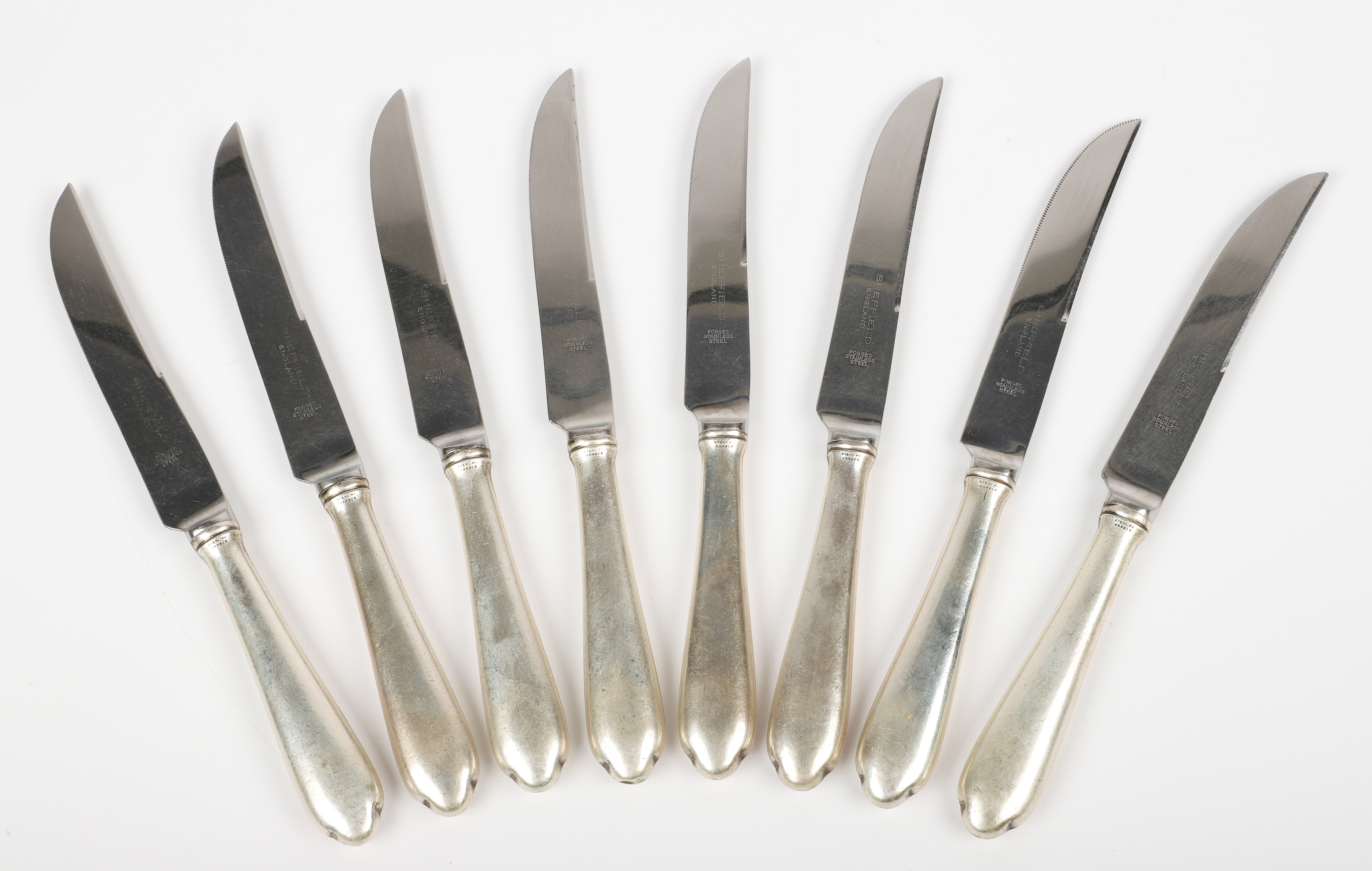 (8) Sterling handled steak knives, forged
