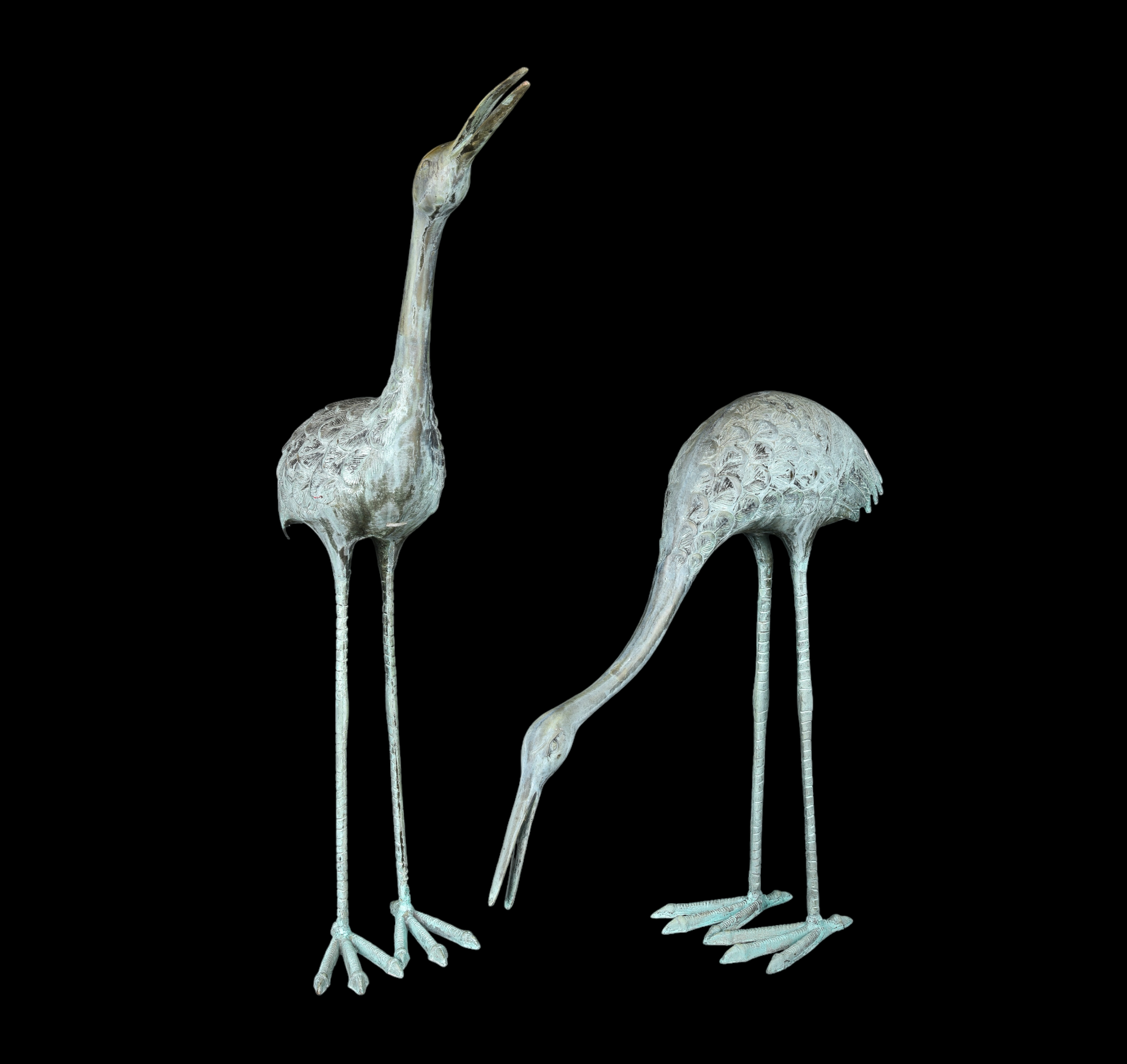 Pair of cast metal garden cranes, verdigris