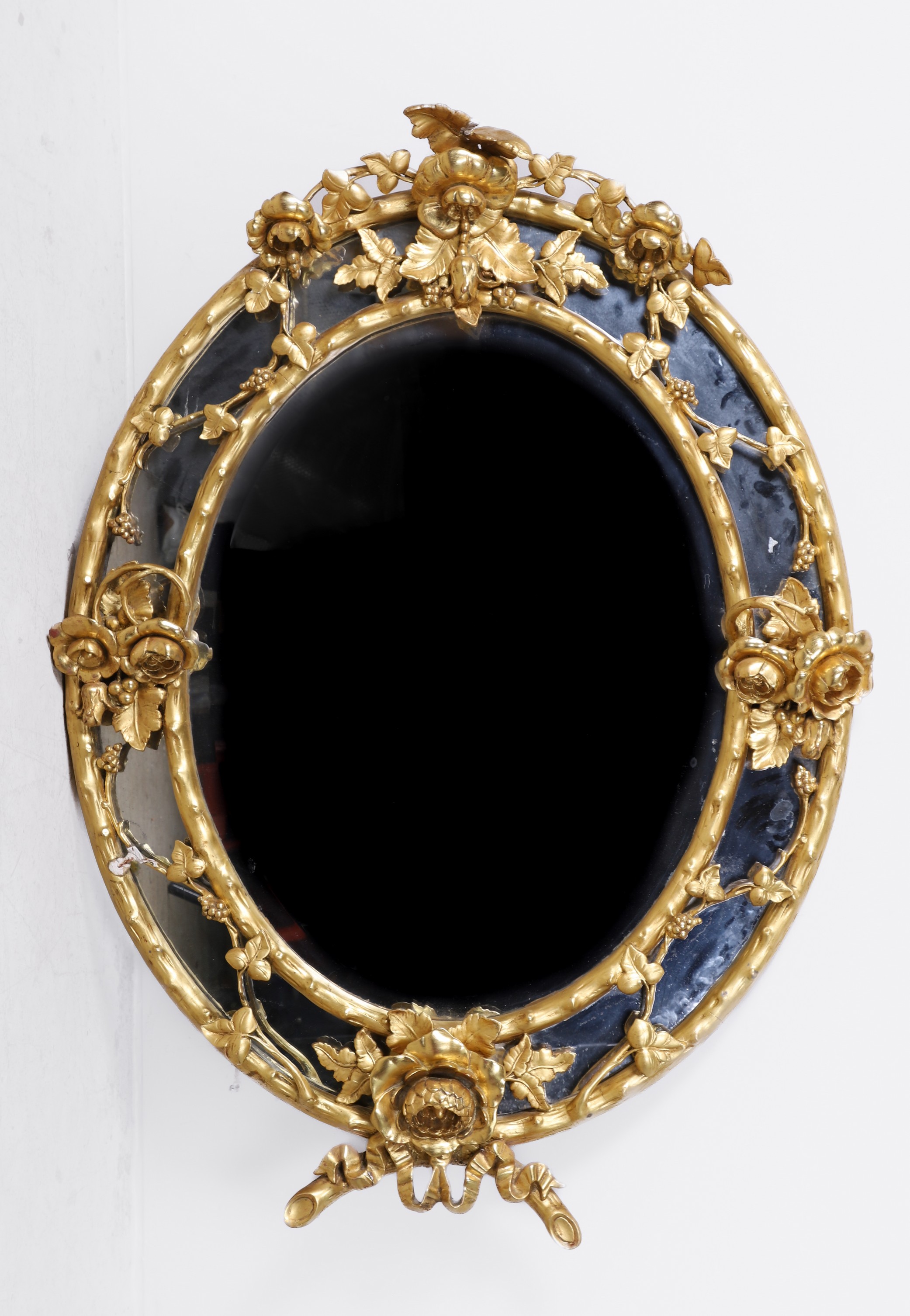 Floral oval gilt hanging wall mirror,
