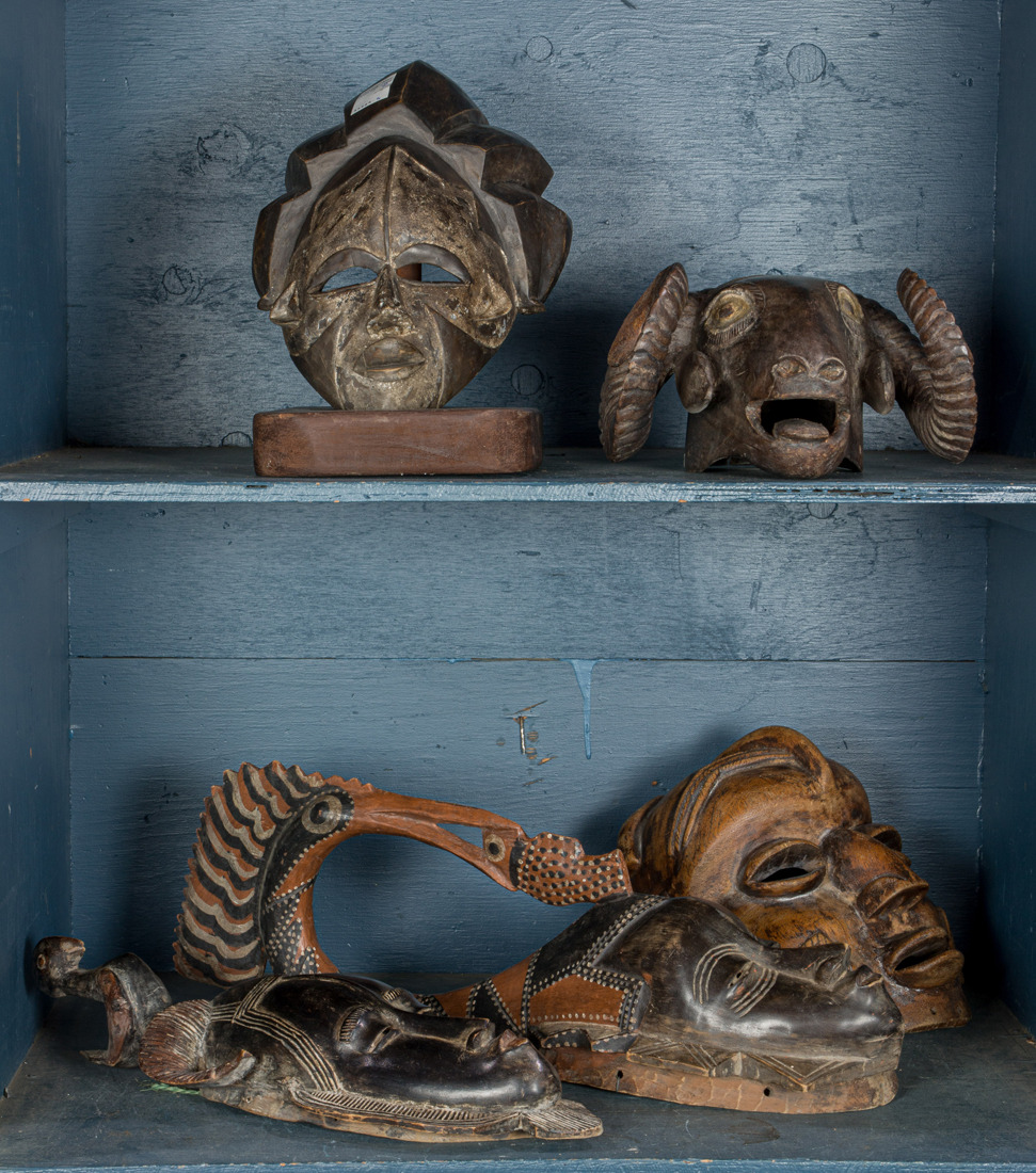 A GROUP OF FIVE TRIBAL CARVED WOOD MASKS