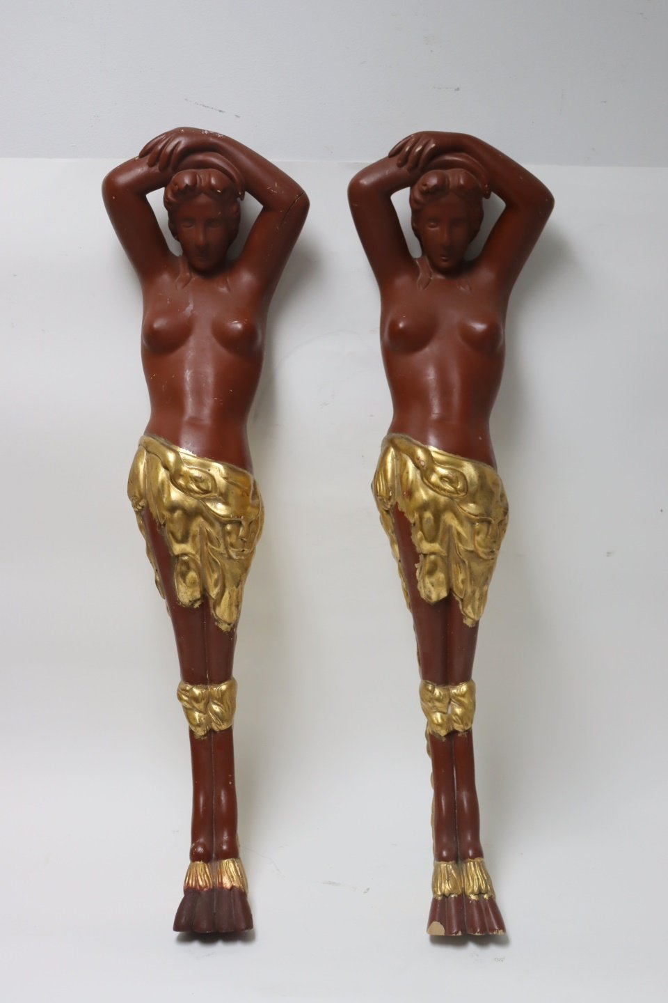 A PAIR OF RED & GILDED WOOD CARYATID
