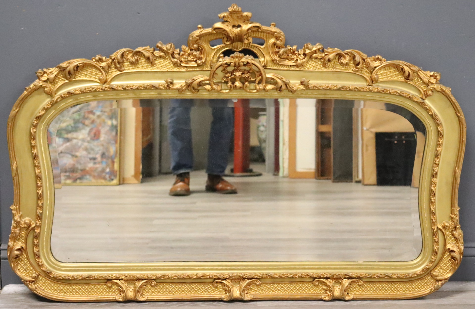 GILT FRAMED OVER MANTLE MIRROR.