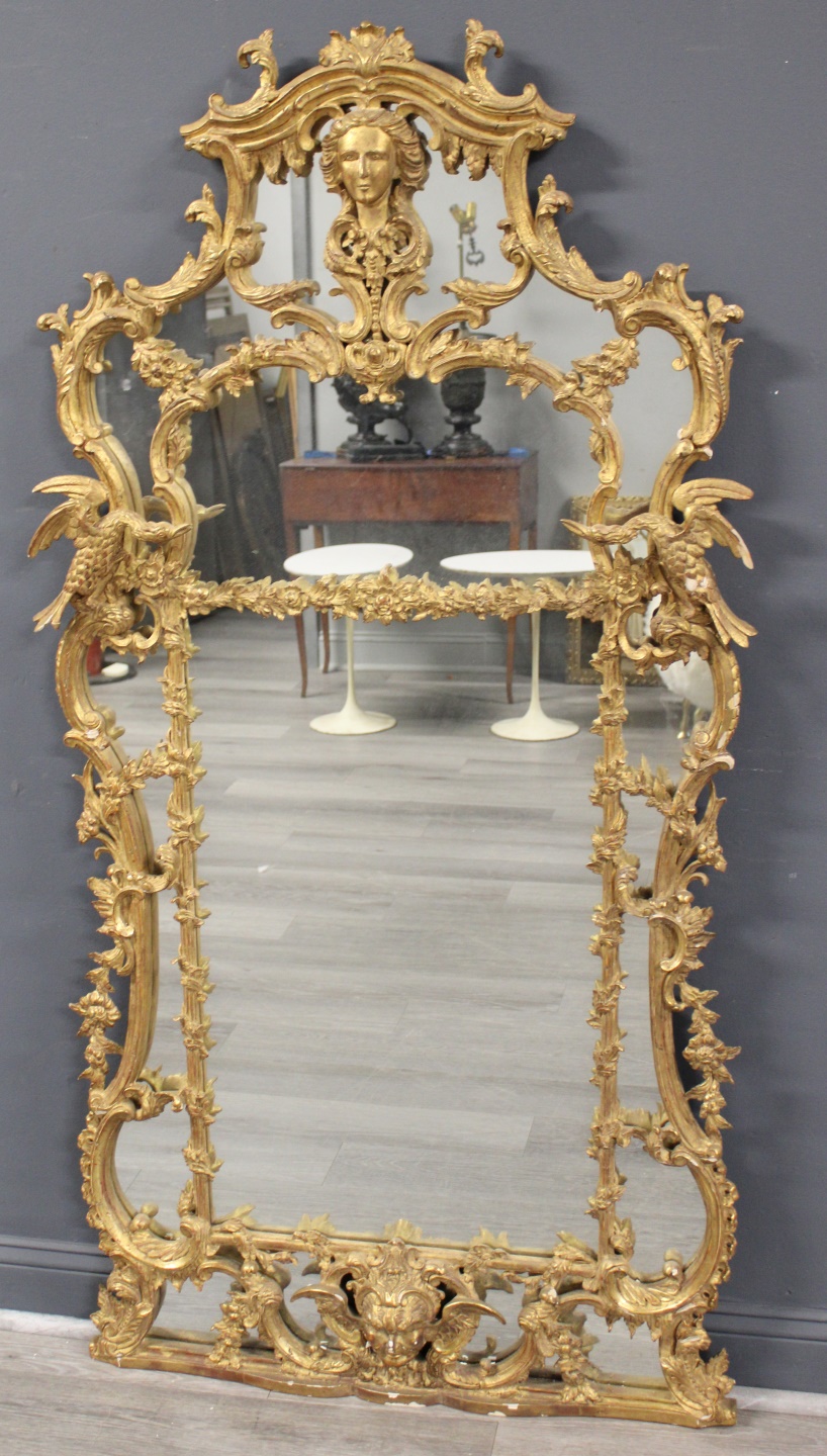 A CARVED GILTWOOD MIRROR IN THE 3b7e2c