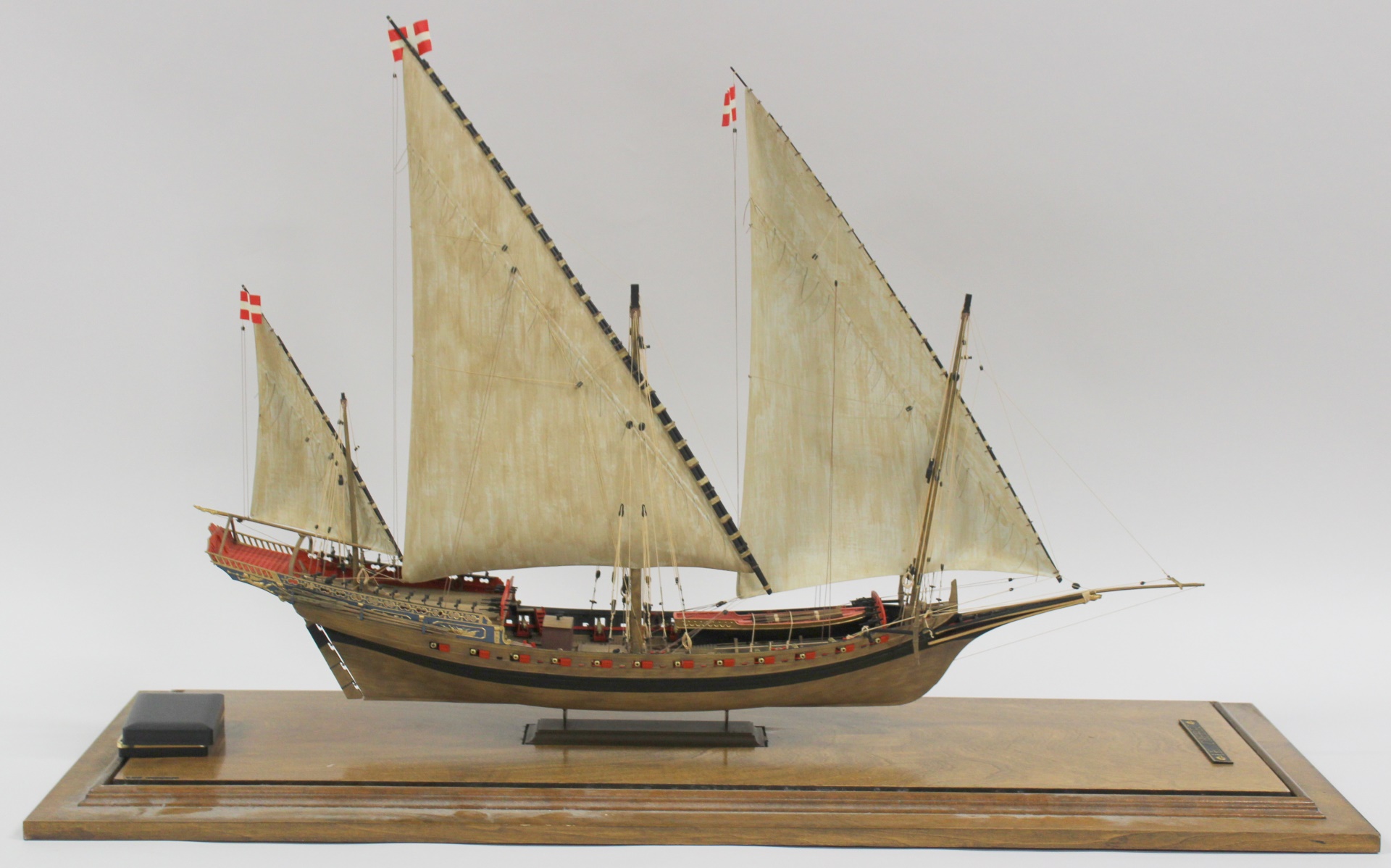A LARGE MODEL SHIP IN DISPLAY CASE