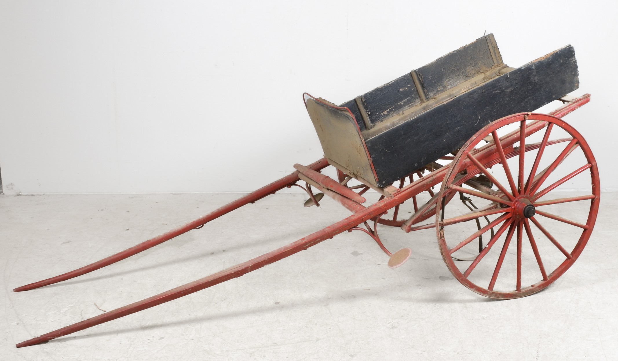 Red and black painted horse drawn wagon,