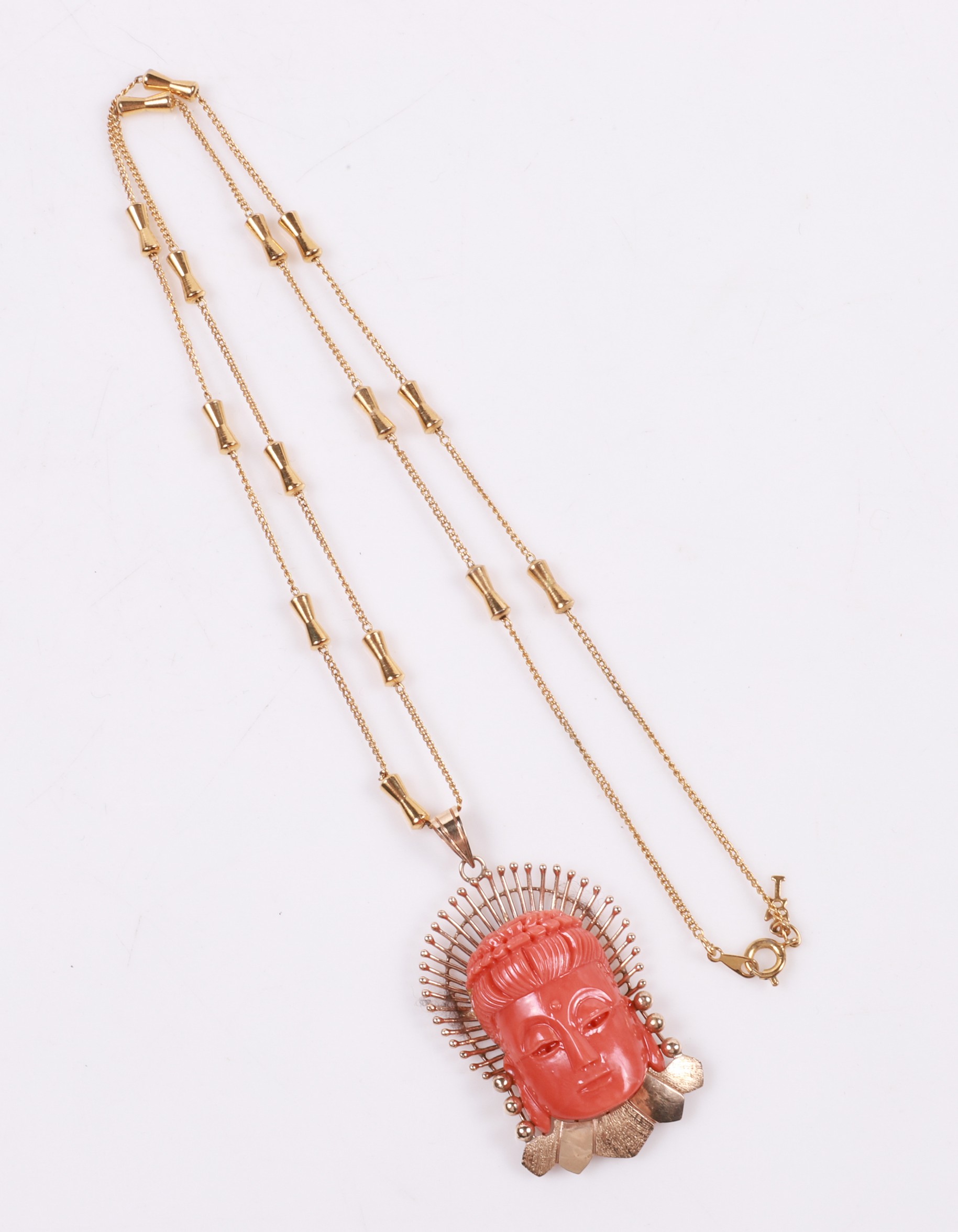 An 18K carved coral pendant, marked