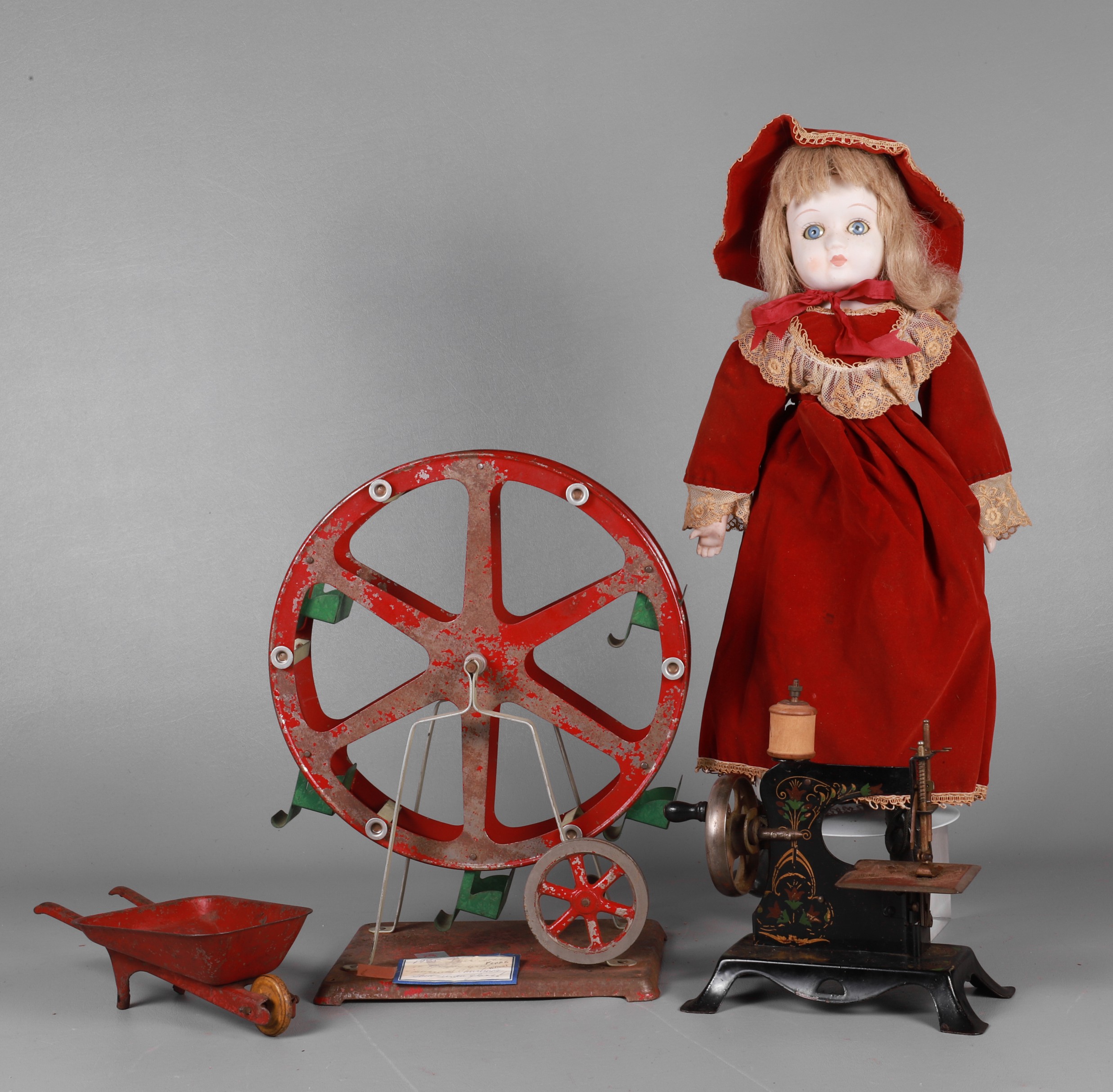 Doll, tin toys and sewing machine to
