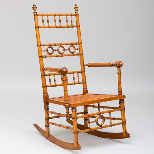 FAUX BAMBOO AND CANED ROCKING CHAIR,