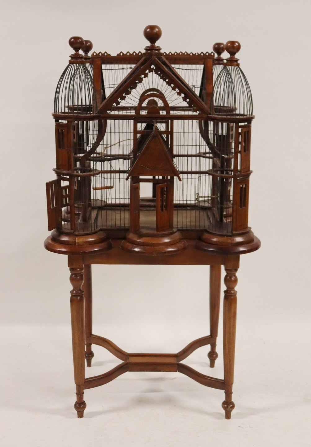 A VINTAGE CARVED MAHOGANY BIRDCAGE