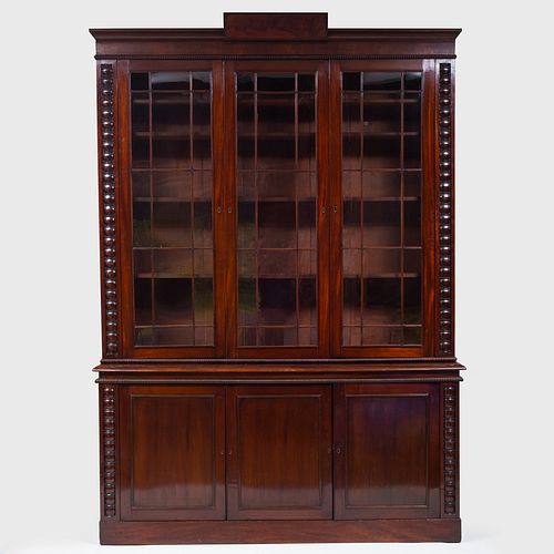 LATE REGENCY CARVED MAHOGANY BOOKCASEIn