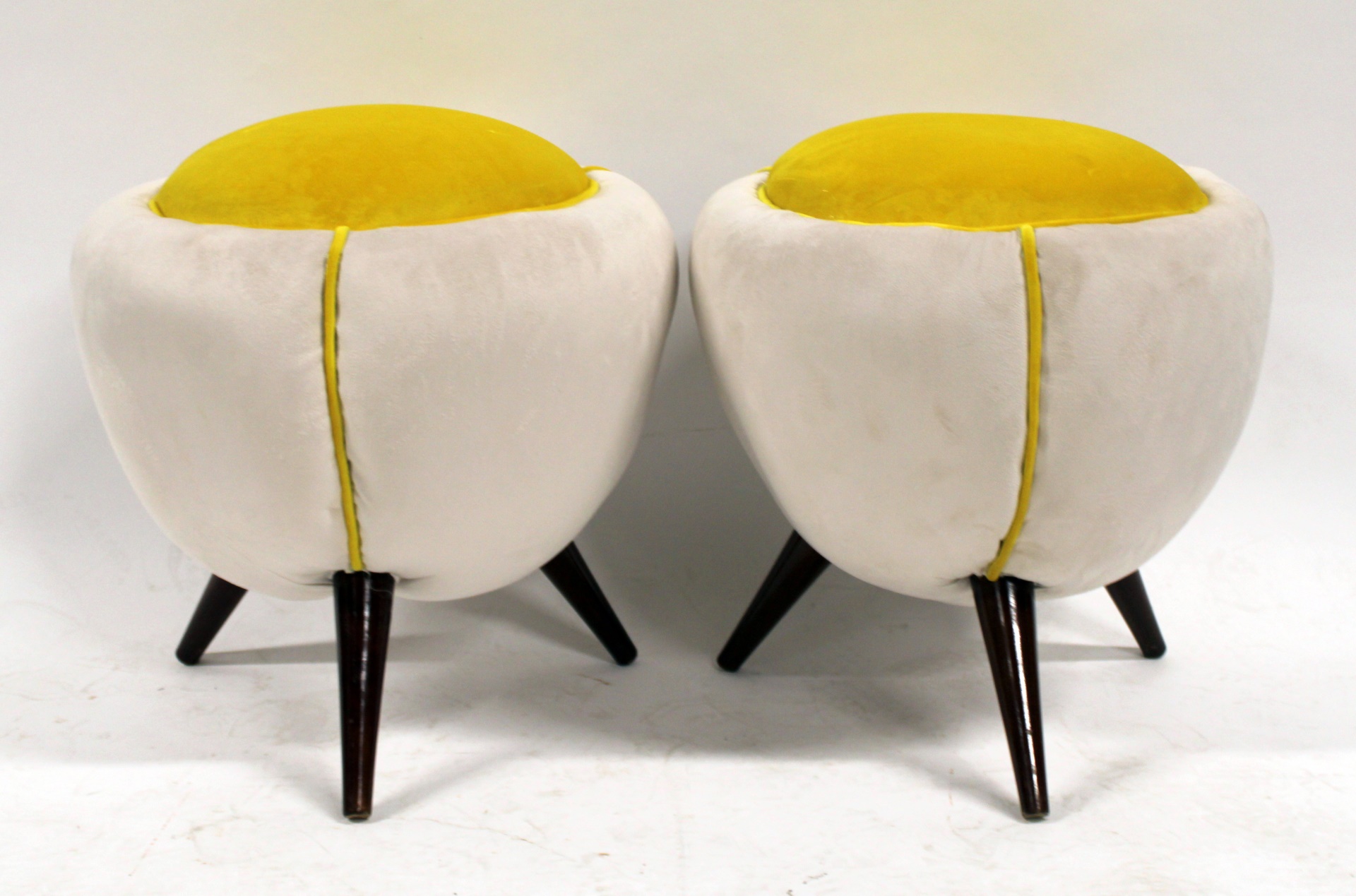 A PAIR OF POUF FORM 3 LEGGED UPHOLSTERED