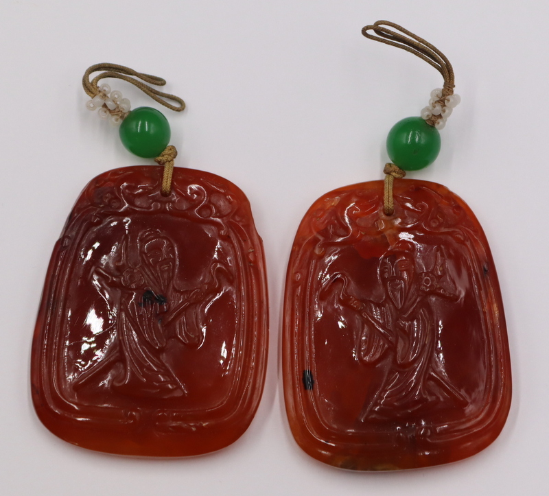 (2) CHINESE CARVED CARNELIAN PENDANTS.