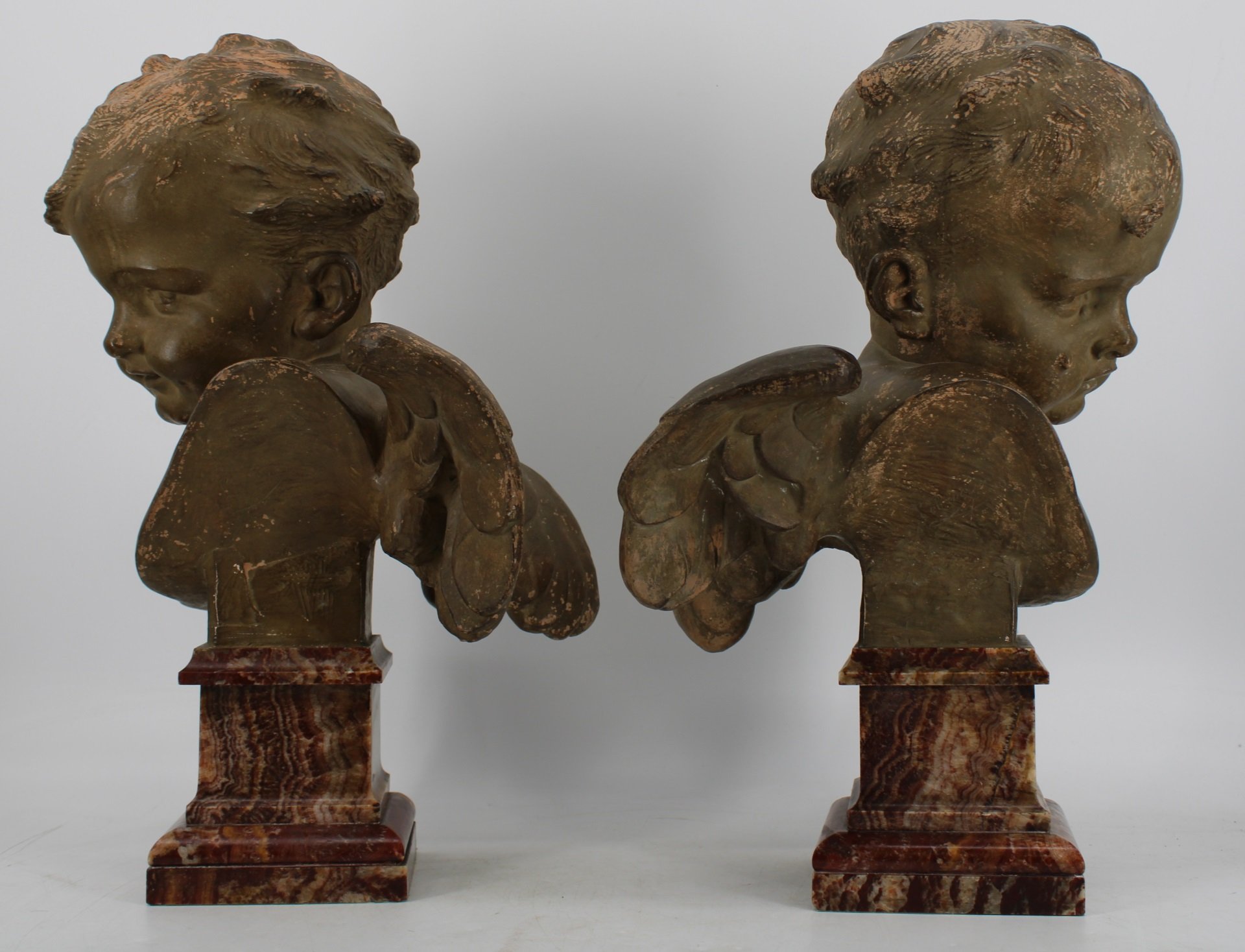A LARGE PAIR OF TERRACOTTA WINGED