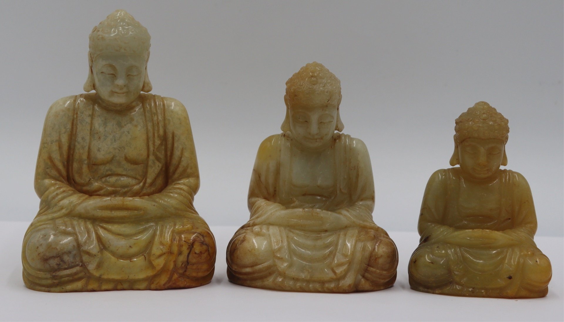 (3) CARVED JADEITE SEATED BUDDHAS.