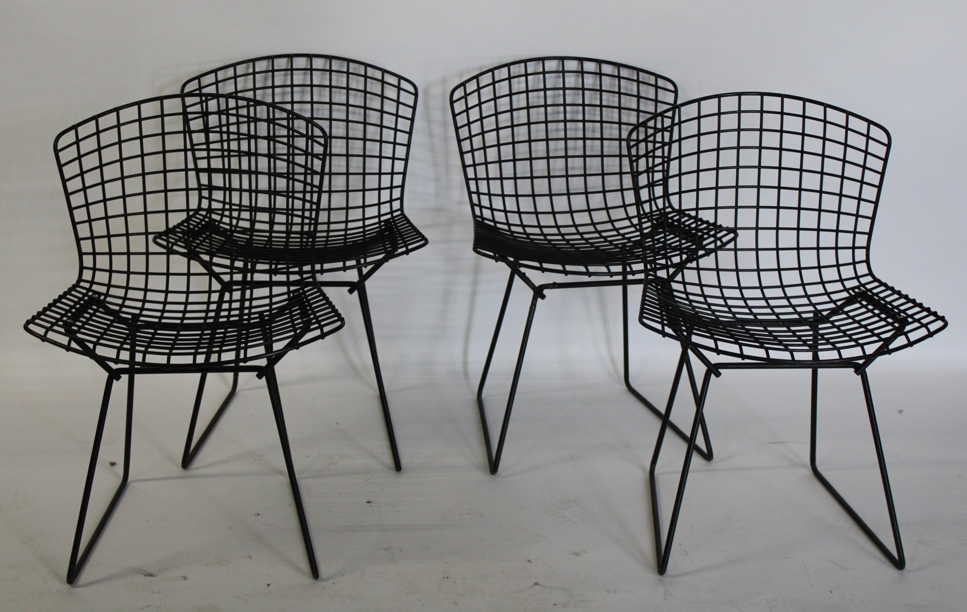 4 HARRY BERTOIA PATINATED METAL CHAIRS.