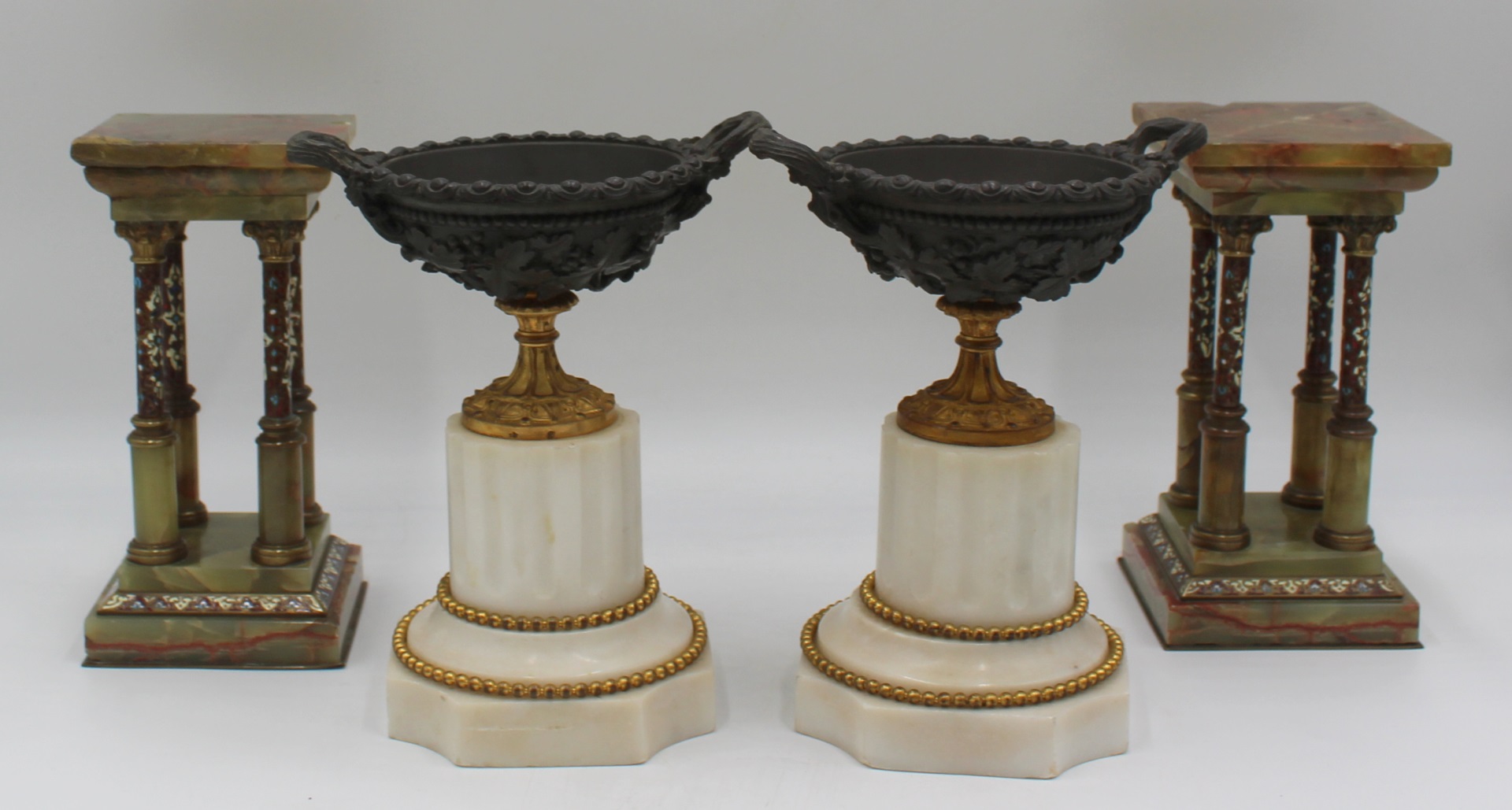 AN ANTIQUE PAIR OF BRONZE URNS