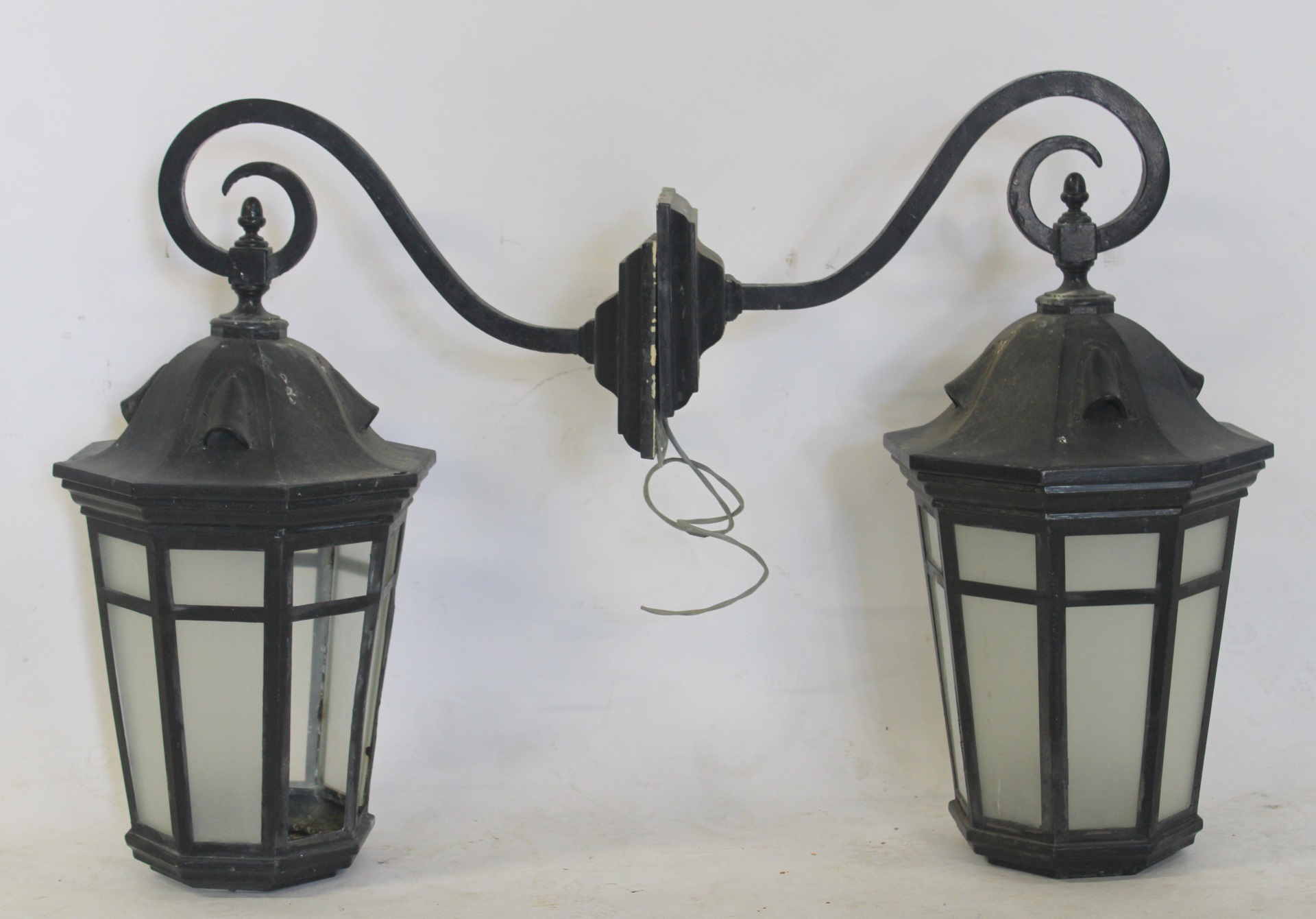 AN ANTIQUE PAIR OF PATINATED METAL LANTERNS