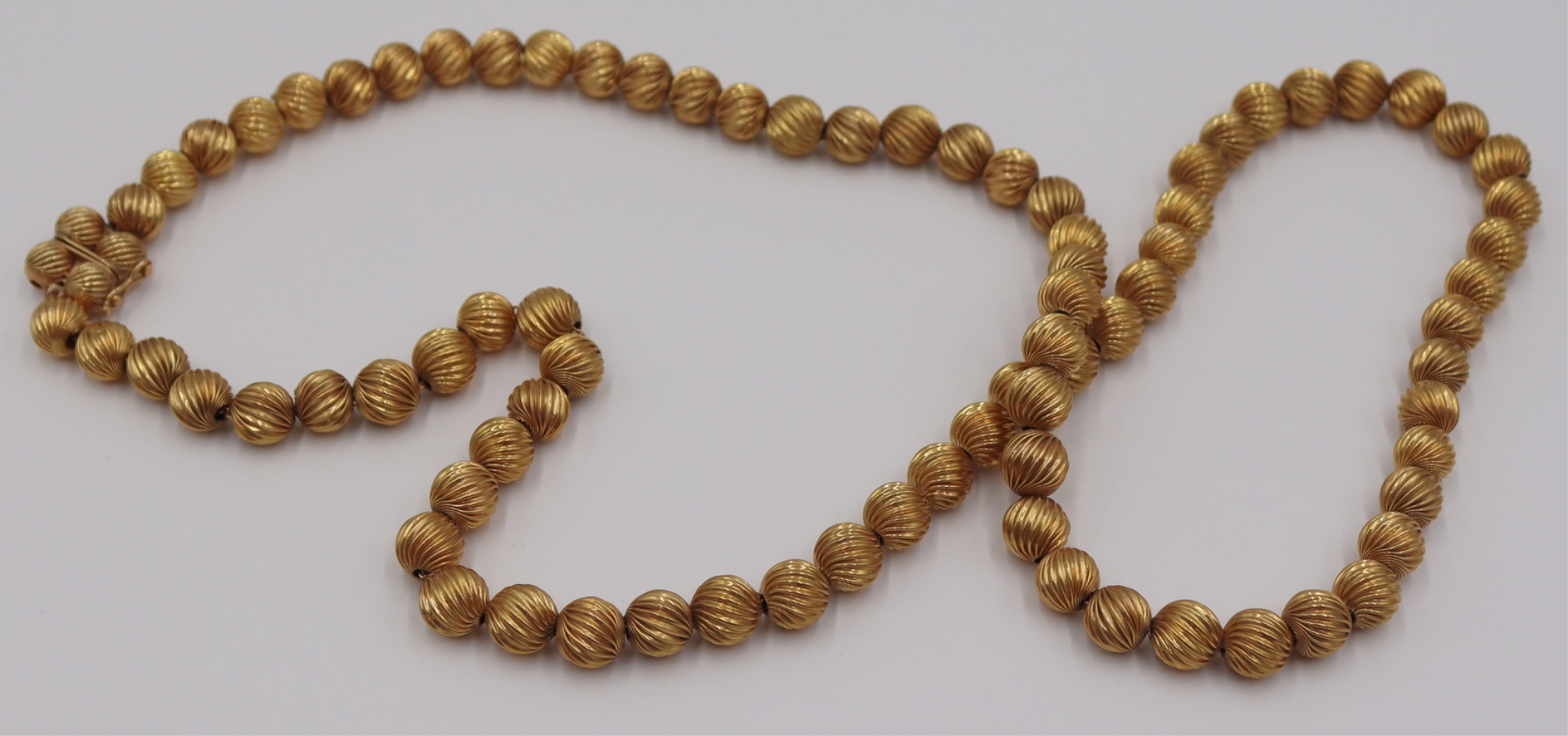 JEWELRY. 14KT GOLD RIBBED BEADED