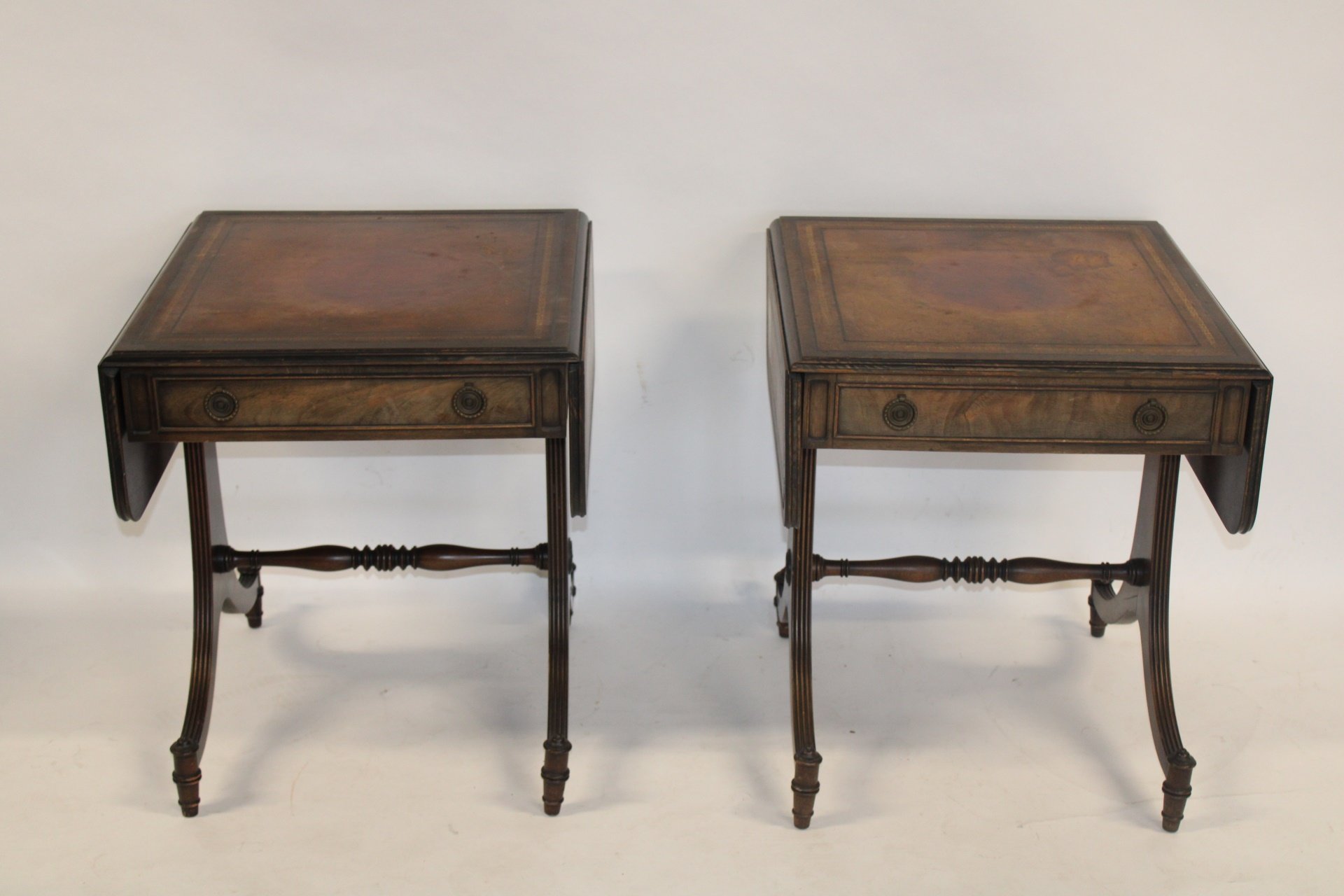 AN ANTIQUE PAIR OF MAHOGANY LEATHERTOP