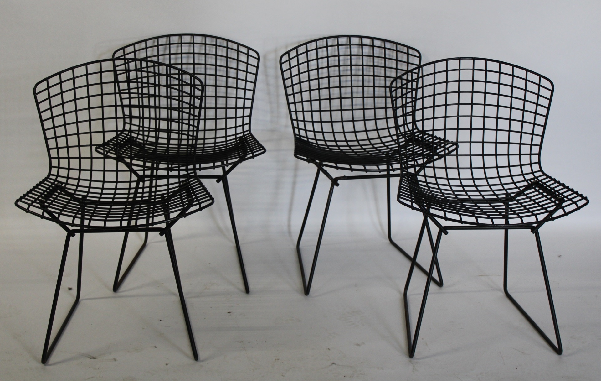 4 HARRY BERTOIA PATINATED METAL CHAIRS.