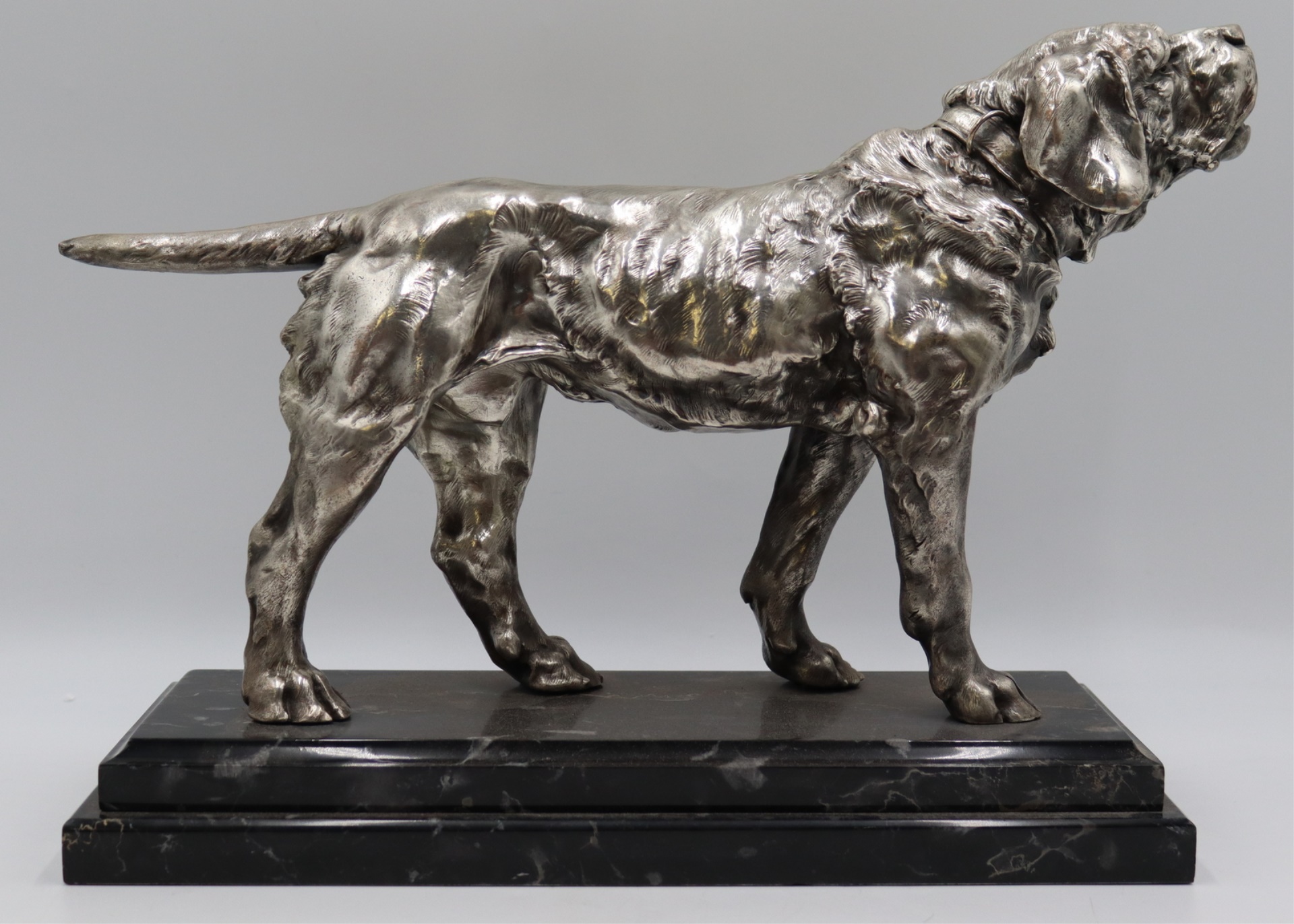 SILVERED BRONZE HOWLING DOG STATUE.