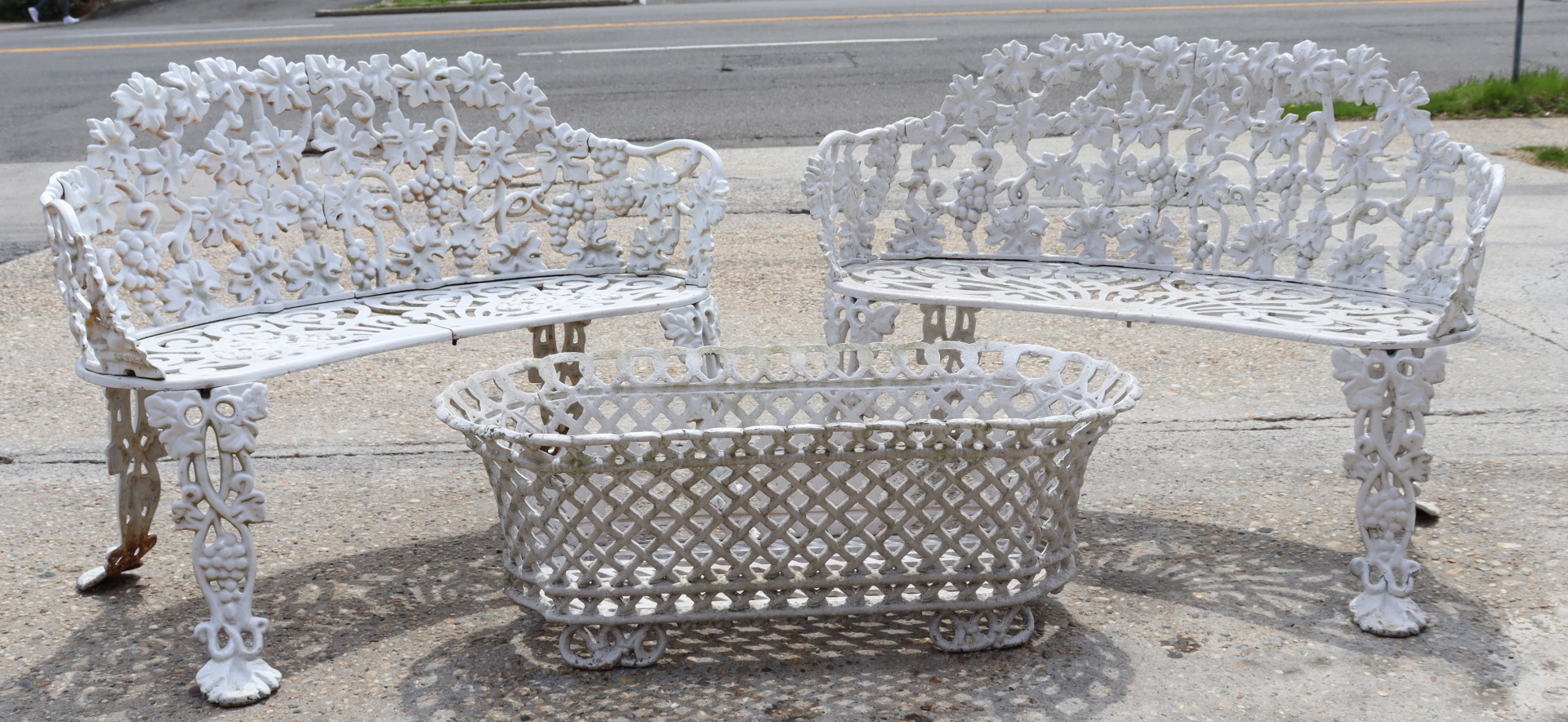 AN ANTIQUE PAIR OF CAST IRON BENCHES