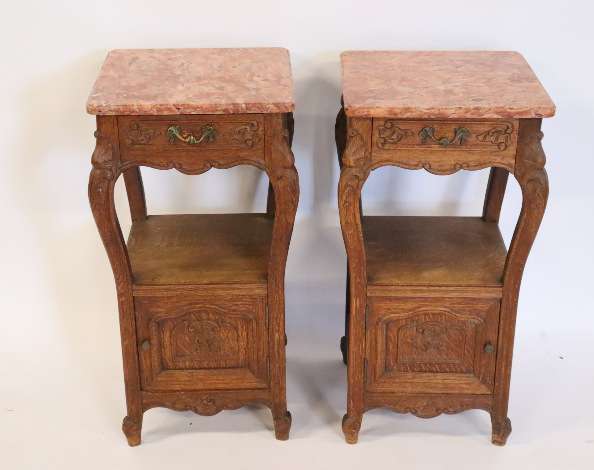 AN ANTIQUE PAIR OF CARVED OAK MARBLETOP