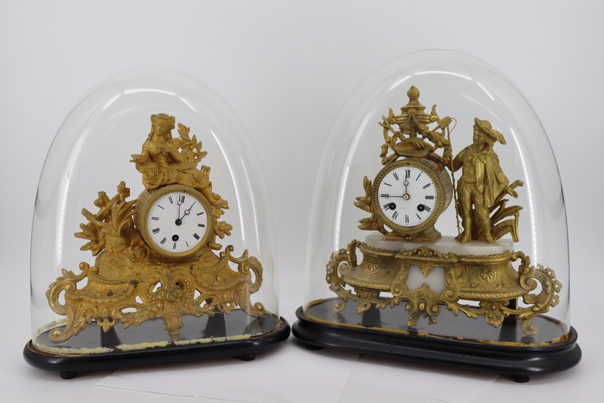 TWO FRENCH GILT BRONZE CLOCKS IN GLASS