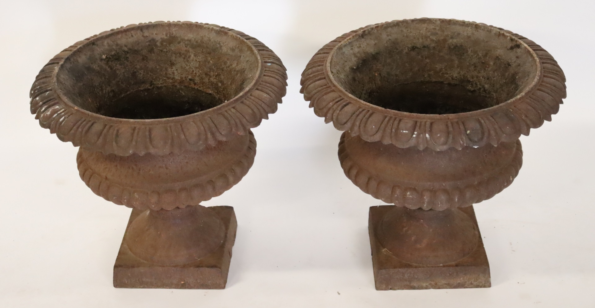 PAIR OF CAST IRON PEDESTAL URNS