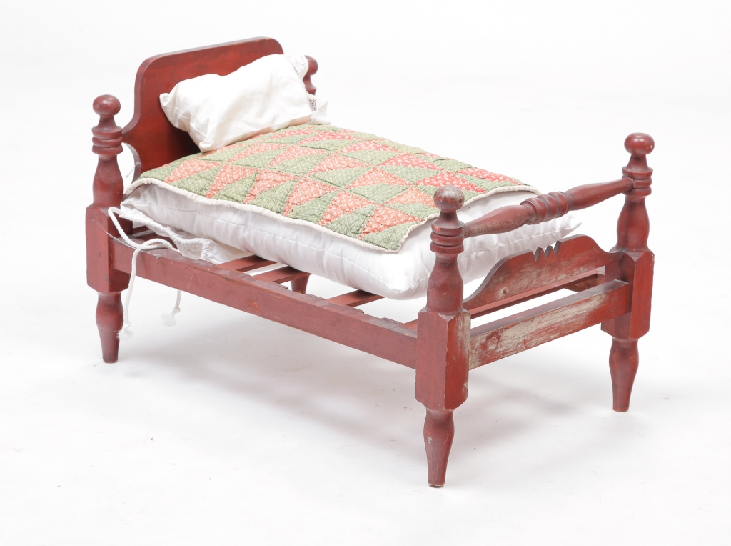 COUNTRY EMPIRE DOLL BED WITH DRESSINGS.