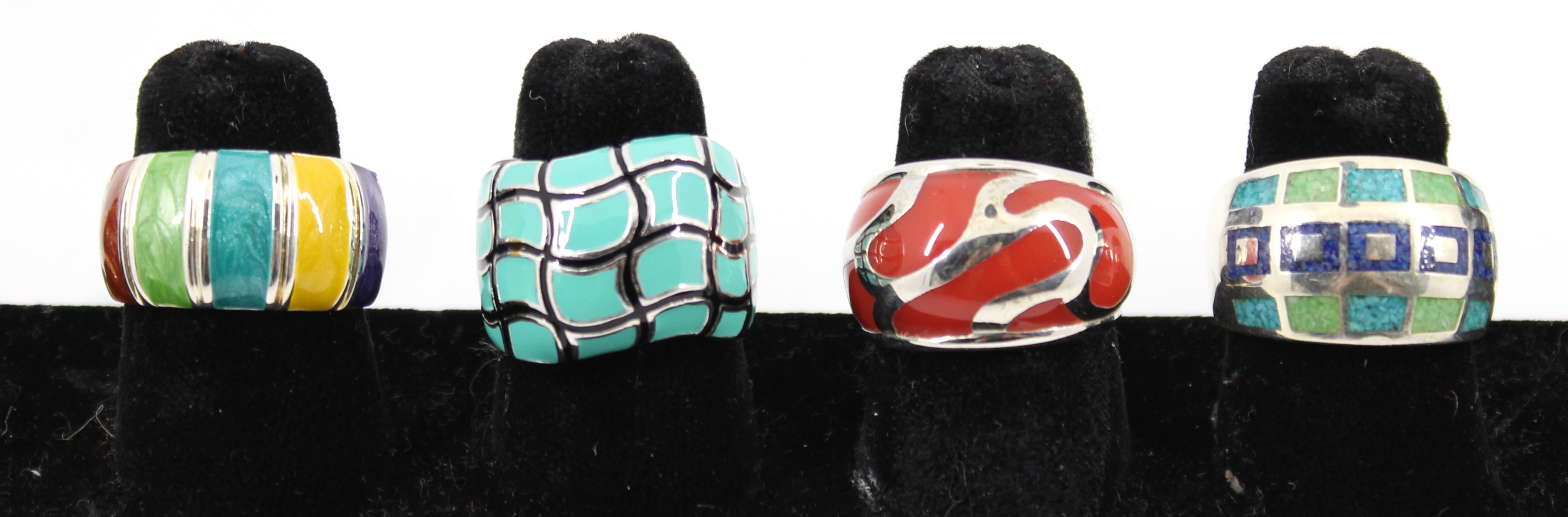 FOUR SILVER AND ENAMEL WIDE RINGS,