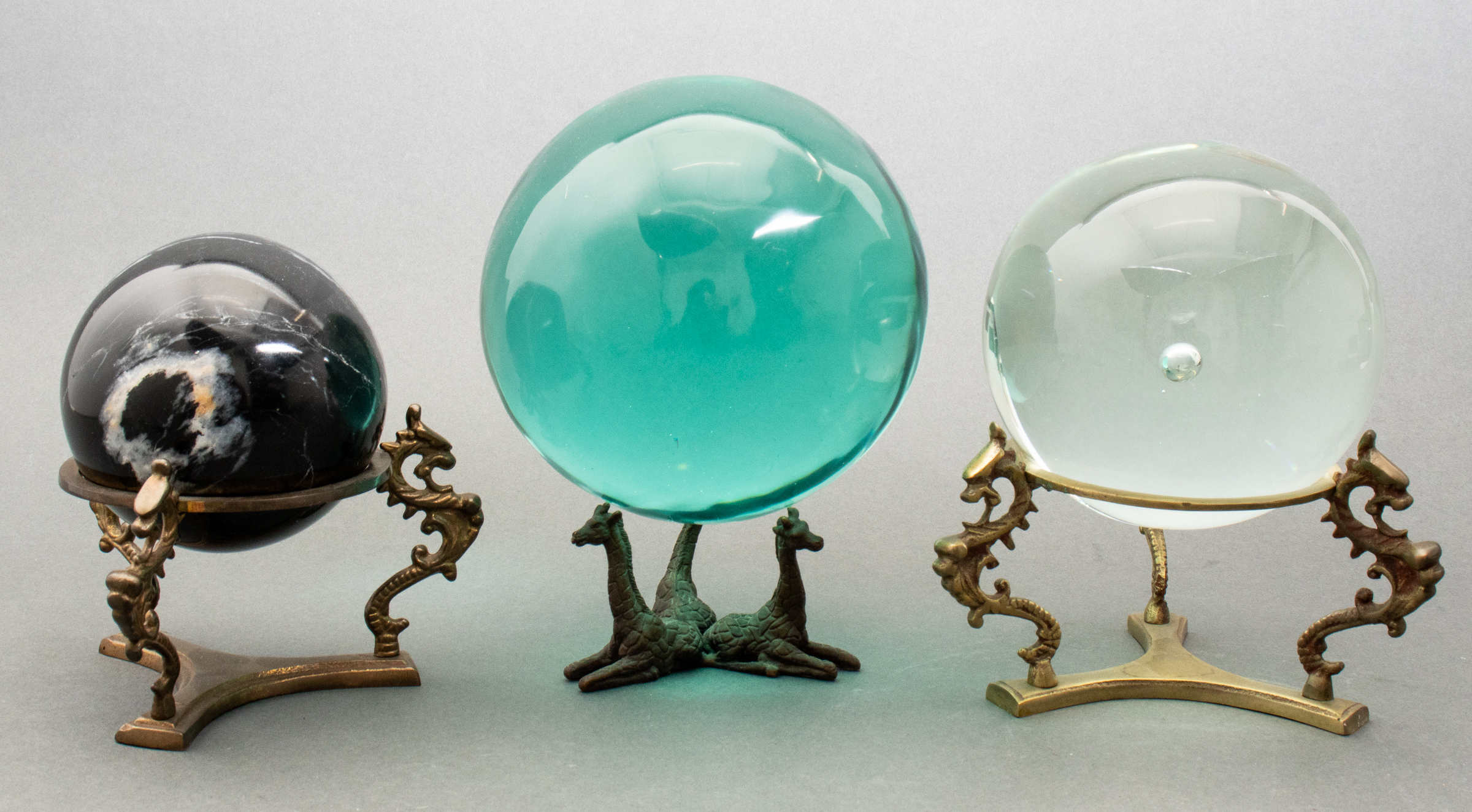 COLLECTION OF ORBS ON ANIMAL STANDS,