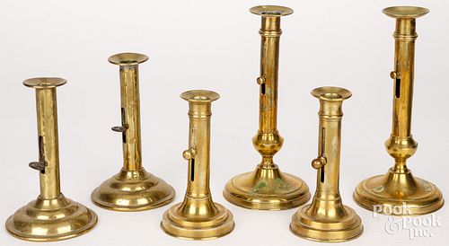 SIX BRASS PUSH UP CANDLESTICKS,