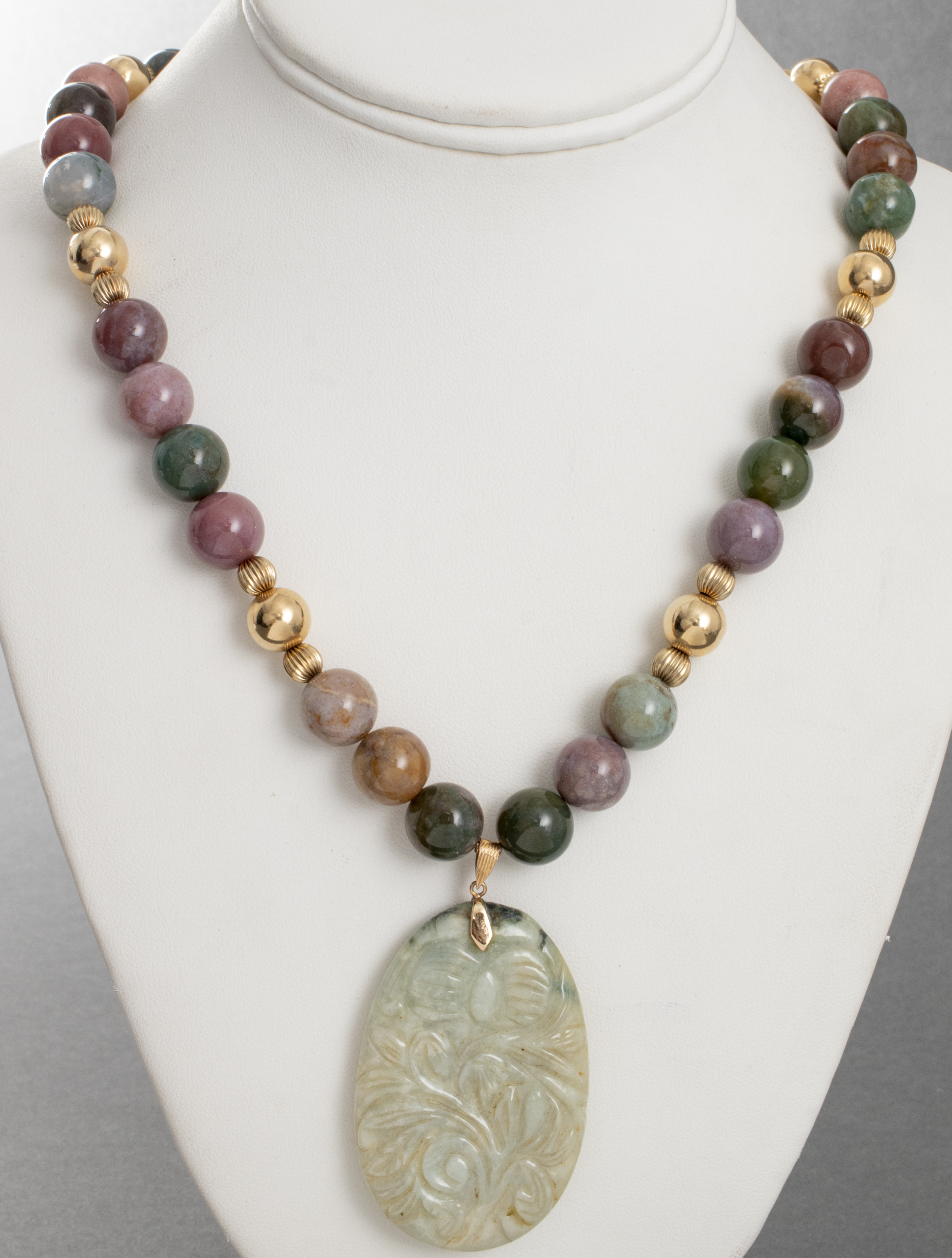 CARVED JADE COLORED STONE PENDANT