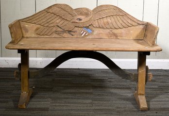 An antique carved bench with a patriotic