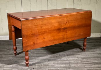 A 19th C. cherry drop leaf table,