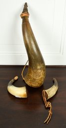 Three antique powder horns, including