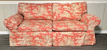 A slip covered two cushion sofa  3c88bb