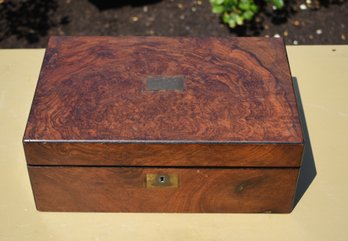 An antique burl-wood desk box with