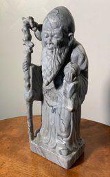 A vintage carved stone Asian elder