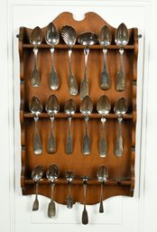 Sixteen coin silver spoons in a