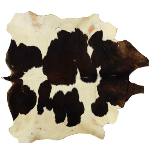 A vintage cow hide rug, 210 x