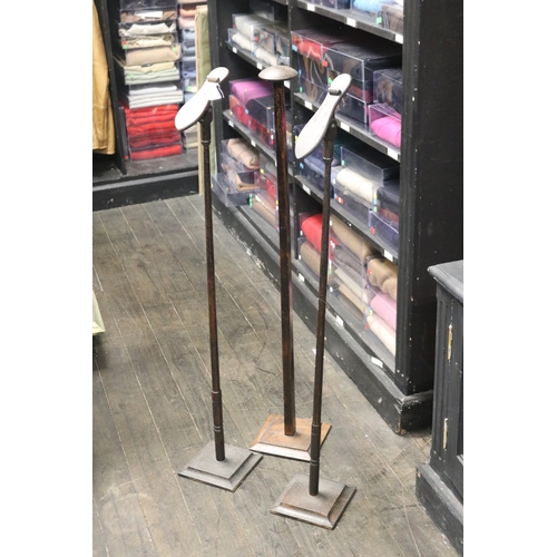 Four tall shop shoe display stands,